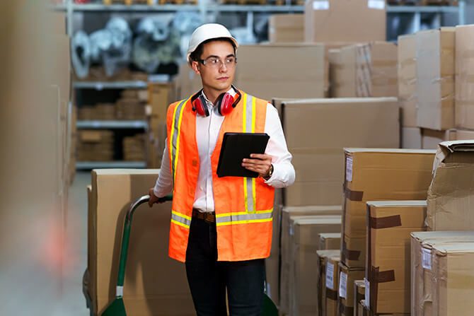 logistic warehouse worker delivering boxes