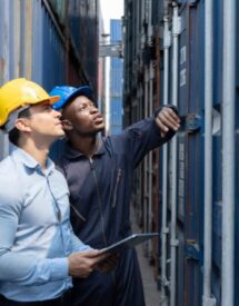 Logistics professionals inspecting a shipping container under EXW and DDP Incoterms
