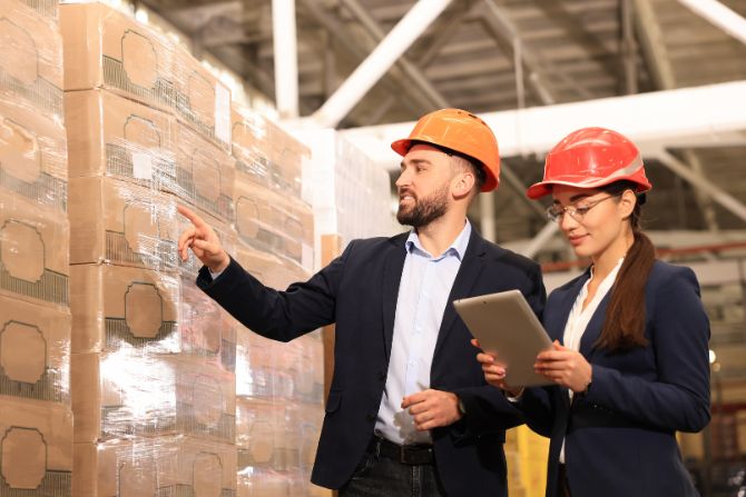 Logistics experts inspecting final delivery of goods in a warehouse