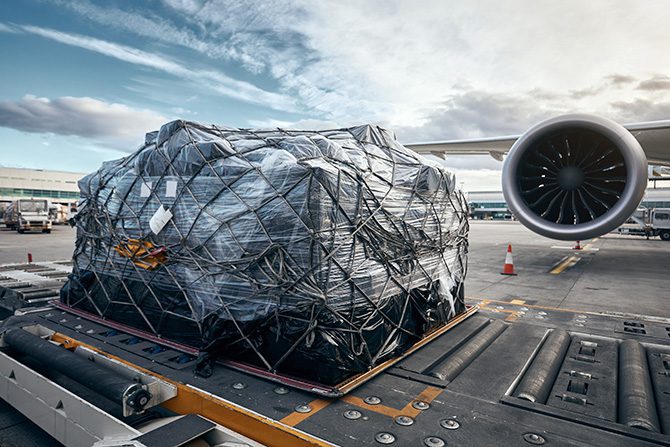 A package going into an airplane for air freight logistics