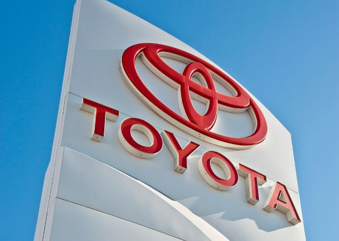 toyota logo on blue sky founder of lean manufacturing principles